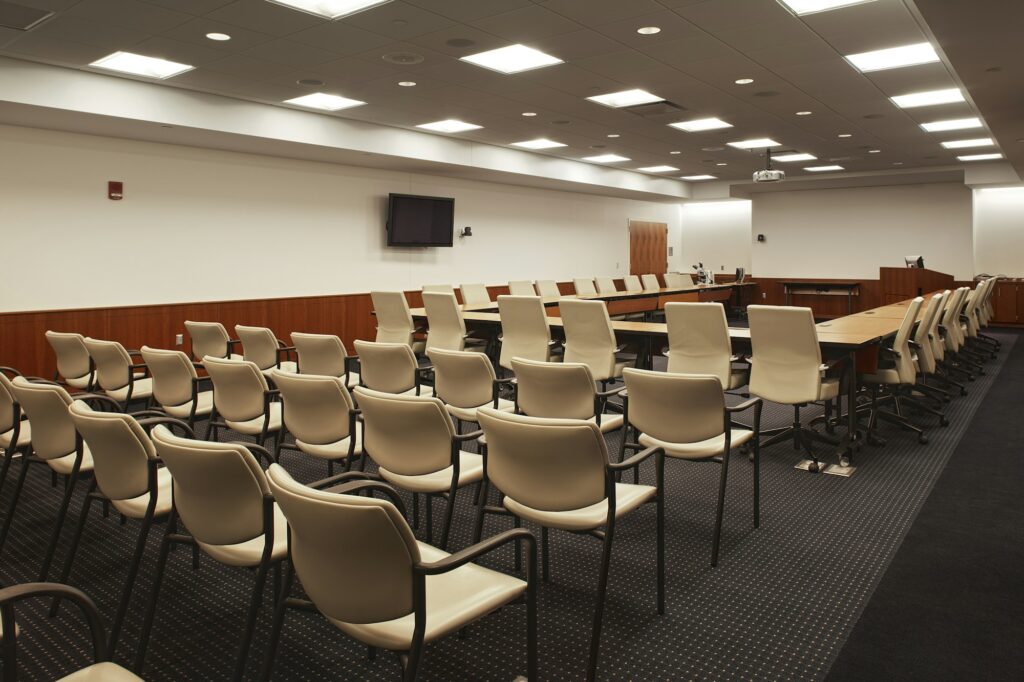 Interior view of a lecture hall or meeting room, a large conference table.